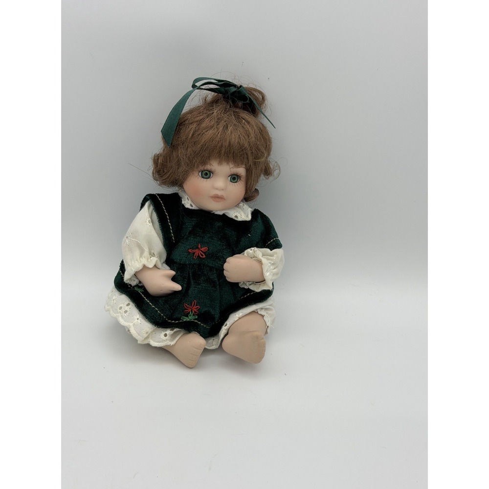 Porcelain baby doll sitting, short hair, moving arms, legs, and head